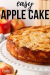 baked apple cake on a decorative white platter.