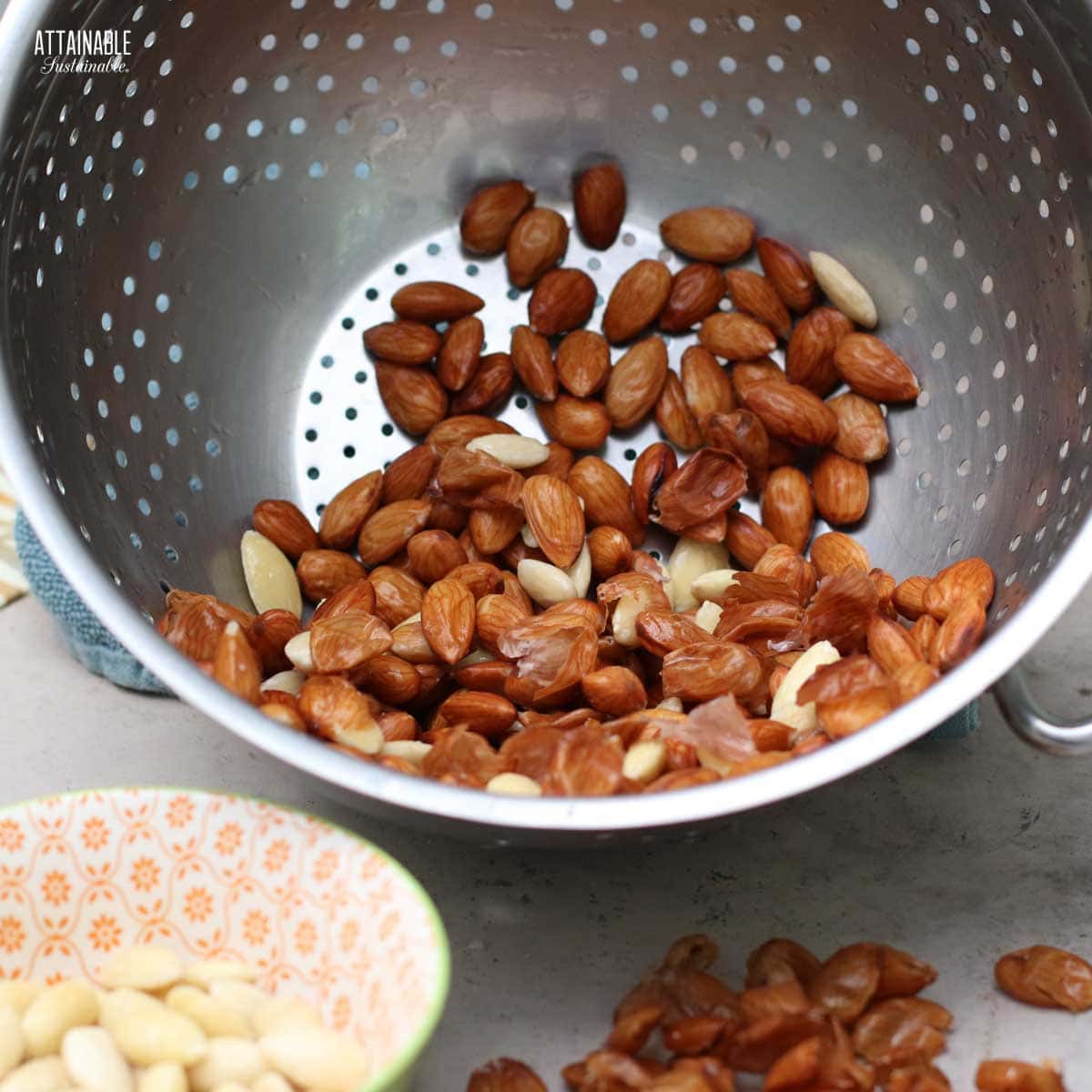 colander full of partially finished blanched almonds.