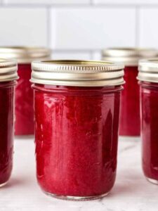 canning jars of plum jam.
