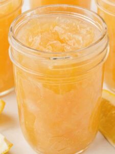 An open jar of homemade lemon marmalade.