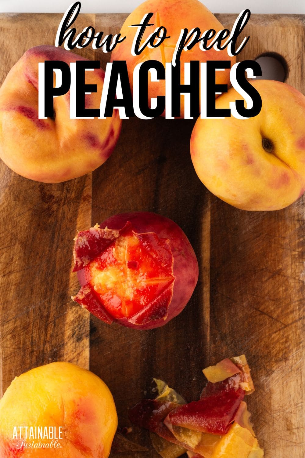 peaches in the process of being peeled, sitting on a wood cutting board.